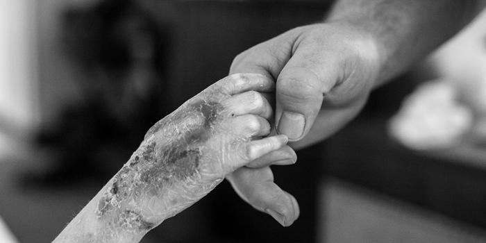 Mother holding child's hand.
