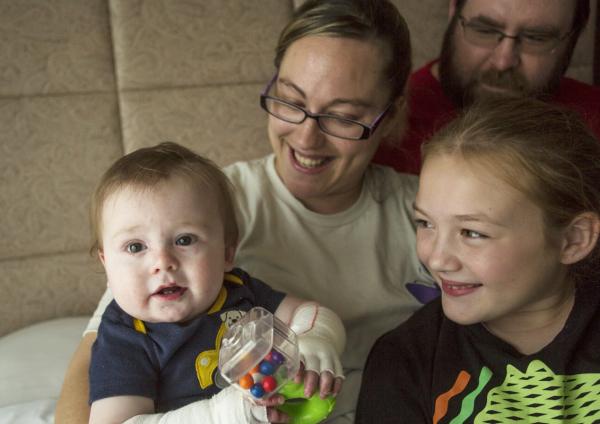 This photo is of a family with a baby with Epidermolysis Bullosa (EB).