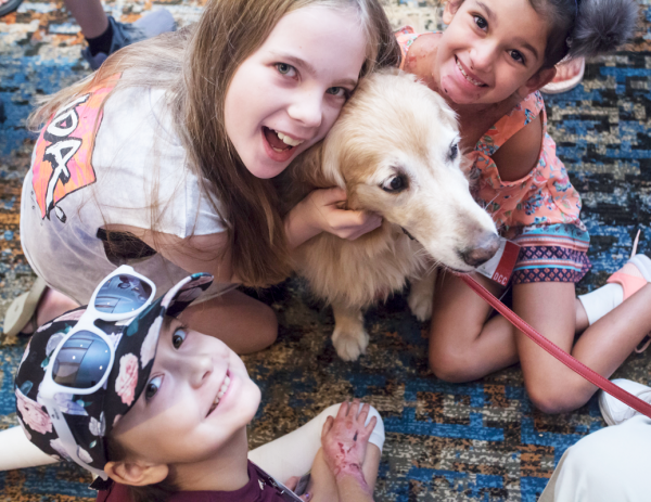 Girls playing with dog